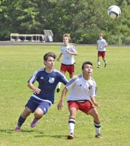 Mario Aguirre, left, a member of Columbus United, looks to make a play during the Presidents Cup Tournament in Columbus this weekend. Photo by: Courtesy photo 