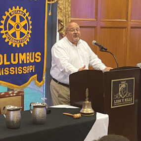 Golden Triangle LINK CEO Joe Max Higgins speaks to Rotary Club of Columbus on Tuesday as Rotarian Carey Edwards (seated) listens - Zack Plair - Dispatch Staff